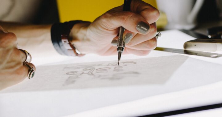 Image of hand with dark nail polish, sketching. By Kelly Sikkema.